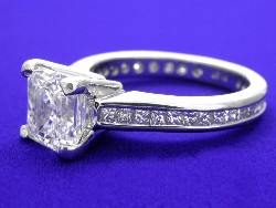 1.74 carat Asscher Cut G VS2 diamond ring with channel-set princess cut diamonds in Platinum mounting.