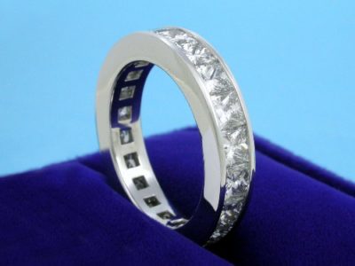 Custom diamond wedding band with 20 Princess cut diamonds with 5.06 total carat weight channel-set in platinum mounting 
