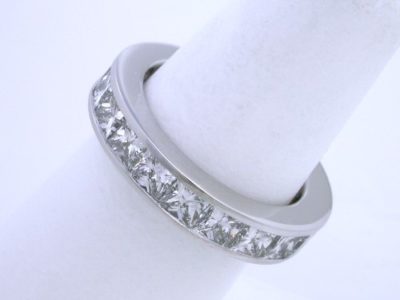 Custom diamond wedding band with 20 Princess cut diamonds with 5.06 total carat weight channel-set in platinum mounting 