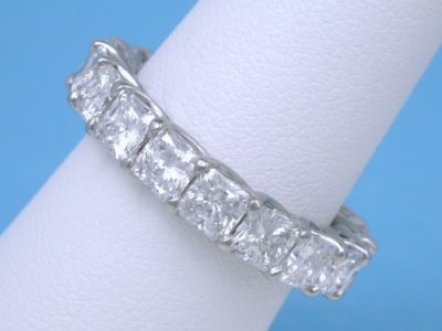 Eternity band with 18 shared-prong set square radiant cut diamonds (4.84 total carat weight) in trellis-style shank
