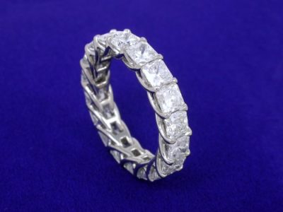 Trellis-style band with shared-prong set square radiant diamonds