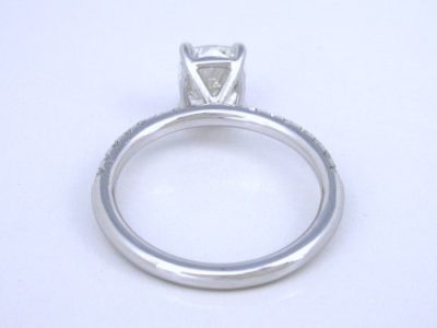 Cushion cut diamond ring with 18-karat white-gold and pave-set diamond mounting
