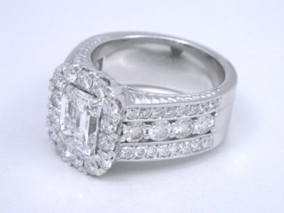 Diamond  ring with 1.20-carat emerald cut diamond prong-set in an 18-karat white-gold custom mounting with 1.42 total carat weight of round brilliant cut diamonds 