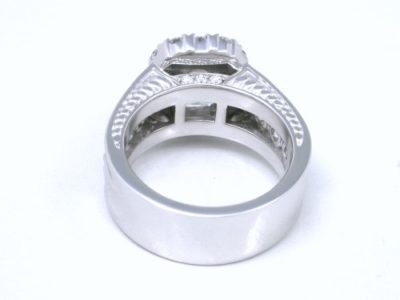 1.20-carat emerald cut diamond prong-set in an 18-karat white-gold custom mounting with hand-carved designs on the side of the shank