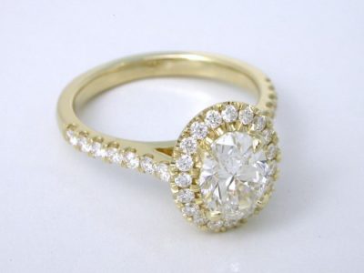 14-karat yellow-gold mounting with U-set round diamonds 1.3 mm on the halo and 1.5 mm going half way down the shank