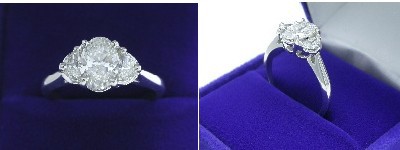 Oval Diamond Ring: 1.00 carat with 1.41 ratio in 0.40 tcw Half Moon Cut diamond three-stone mounting