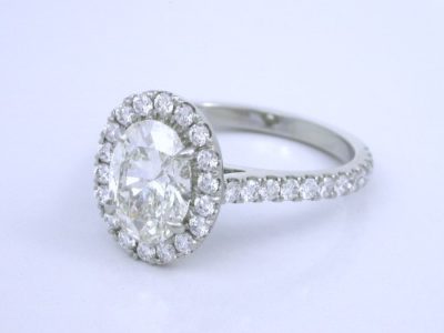 Oval Cut Diamond Ring: 1.50 carat with 1.35 ratio in 0.63 tcw Pave Halo and Shank Mounting