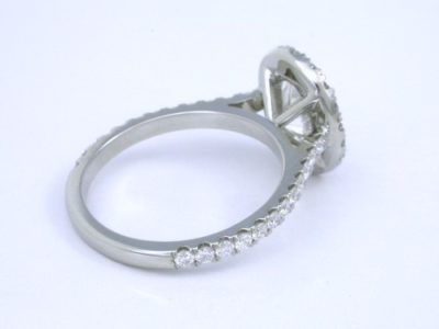 Oval cut diamond ring with pave diamond halo and shank