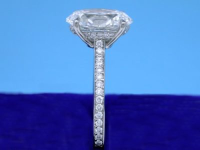 Bez Ambar designer Paloma style platinum mounting with round diamonds pave set on the under bezel of the four-prong basket and going three-fourths the way down the top of the shank