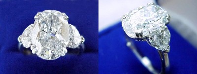 Oval Diamond Ring: 3.02 carat with 1.43 ratio in 0.98 tcw Heart Shaped diamond three-stone mounting