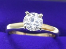 0.70 carat Round Brilliant diamond graded H color, SI1 clarity in 14-karat yellow-gold four-prong Solitaire style mounting