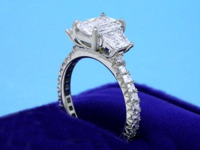 Radiant Cut Diamond Ring: 1.13 carat with 1.33 ratio in 0.60 tcw Brilliant-Cut Trapezoid Three Stone mounting with 0.56 Blaze Cut diamonds