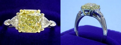 Radiant Cut Diamond Ring: 2.06 carat with 1.04 ratio and Fancy Yellow color in 0.40 tcw Trillion Cut Three Stone mounting