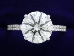 2.56 carat Round Brilliant diamond in Cathedral style mounting with 0.22 total carat weight of pave set diamonds